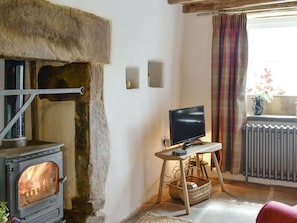Warming wood burner within living room | Springlea Cottage, Deanscales, near Cockermouth