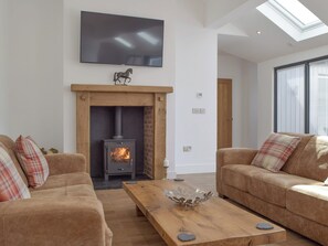 Welcoming living area with wood burner | Manor Lodge Stables, Wiston, near Haverfordwest
