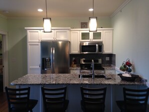 Fully Stocked Kitchen with bar seating.