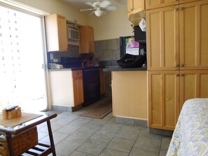 Section of the studio, with view of the full alcove kitchen.