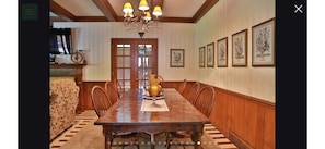 Dining room open concept to living room and sunroom with 4 chair barrel table. 