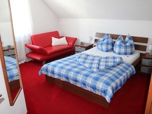 Schlafzimmer mit französischem Doppelbett, Couch, TV und Wecker