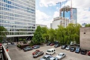An exterior view showing the building’s parking area with surrounding office buildings.