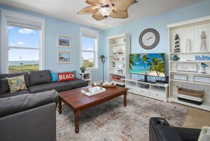 Living room has great bay views, lots of comfortable seating, LED smart TV, & high speed wireless internet.