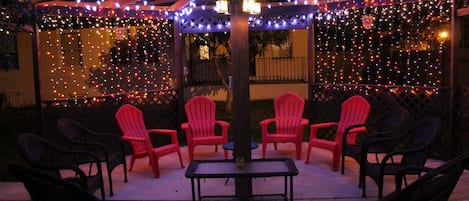 Large gazebo decorated with lights at backyard 
