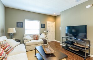 Living room with smart TV and natural lighting.