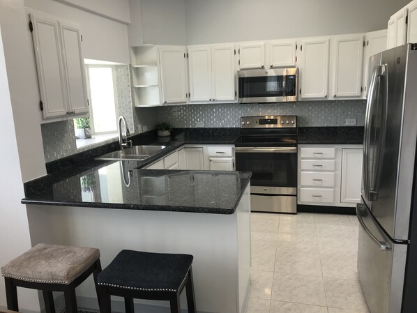 Large modern kitchen with all new appliances, plus expresso machine.