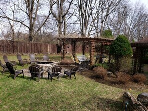 Pergola and huge fire pit fits everyone around it comfortably