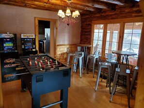 Game room with arcade games and foosball is on the main floor near kitchen & LR