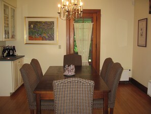 Main House Dining Room with wet bar.  Table will seat 8.  Door opens to porch.
