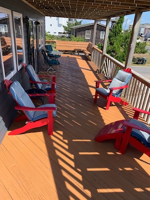 Large, wrap-around front porch with plenty of seating to watch the ocean.