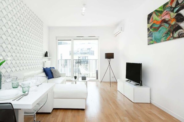 Living room with a comfortable sofa and TV. 