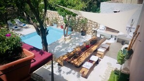 Outdoor dining and pool views from the residence terrace