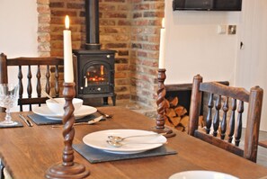 Oak dining table and woodburning stove