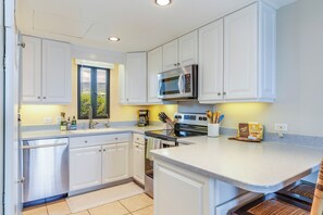A full  kitchen including oils, spices, coffee, tea and more