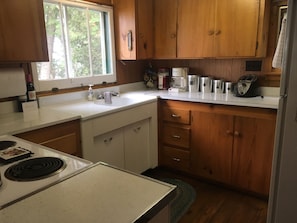 Fully equipped kitchen with full-size stove and refrigerator.