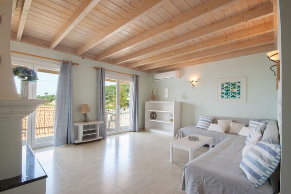 Open plan living room with sea views over Kalimones Bay
