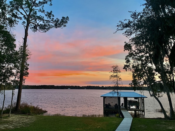 Enjoy stunning lakefront sunsets from the dock, the porch or inside the house.  