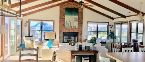 large open living, dining room and kitchen -- with wood burning fireplace