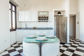 Simple yet modern kitchen alongside Dining table 