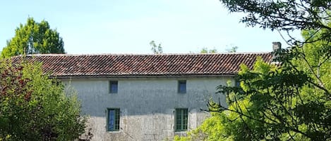 South side of watermill with new green windows,overlooking the river Seugne