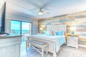 Stylish master bedroom with a wooden accent wall, king-size bed, and warm lighting.