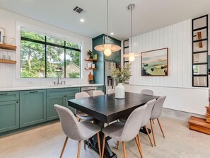 The farmhouse table is expandable to seat 10. Additional chairs provided.