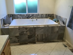 Spa tub in master bath. This bathroom also has a duel head shower 