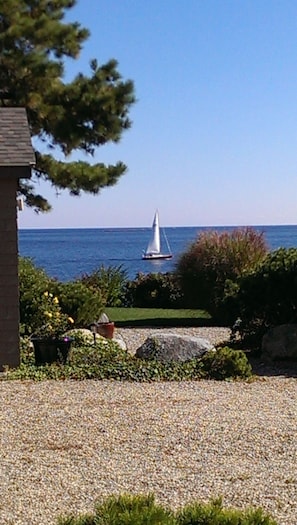 Sailboat passing by Breakwater House