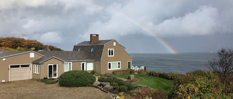 Rainbow over Breakwater House and ocean