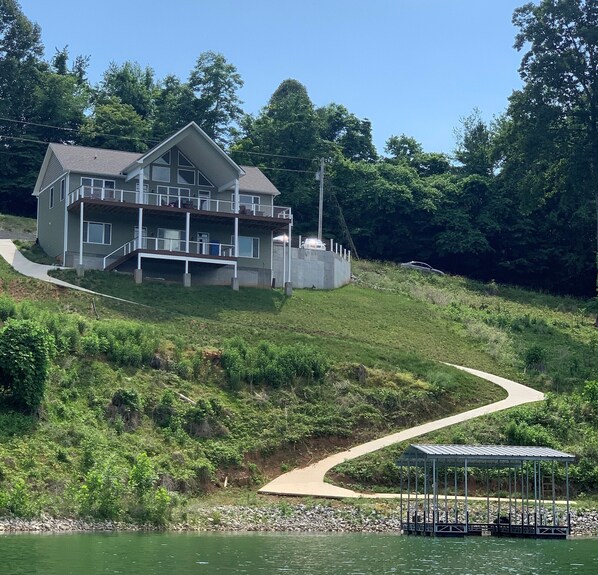 Brand new lakefront custom home with concrete path to your private dock 