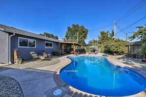 This impressive vacation rental property includes a private yard, pool, & patio.