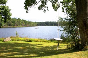 Rope swing w/ view of raft/slide in distance
