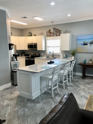 Full kitchen, completely remodeled. Bar seats three. 