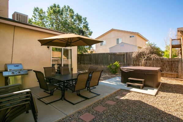 Patio seating for 6 and 4 extra chairs along with gas BBQ grill.