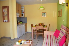 Prepare meals in the kitchenette and enjoy them at the dining table.