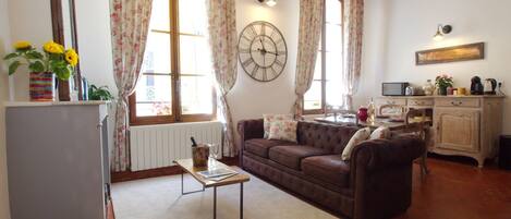 Living area with huge windows and tall beamed ceilings