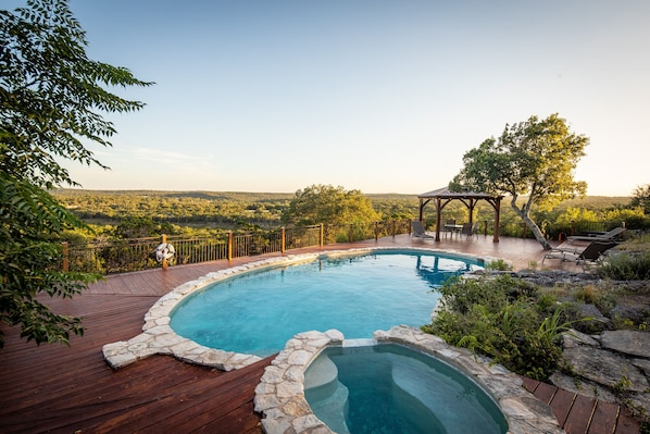 Backyard swimming pool with beautiful hillside view