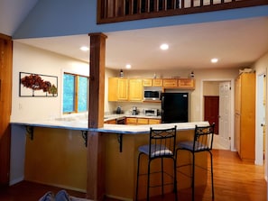 Open to the den, the kitchen has a pull up bar perfect for gathering.