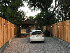 PRIVACY FENCING WITH GATE AND GRAVEL PARKING