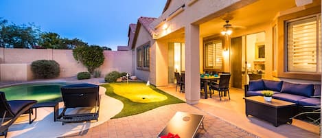 A backyard full of entertainment! Corn hole Game, Putting Green, Heated Pool!