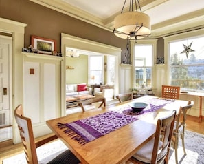 Light-filled full dining room connected to den looking out onto the back deck.