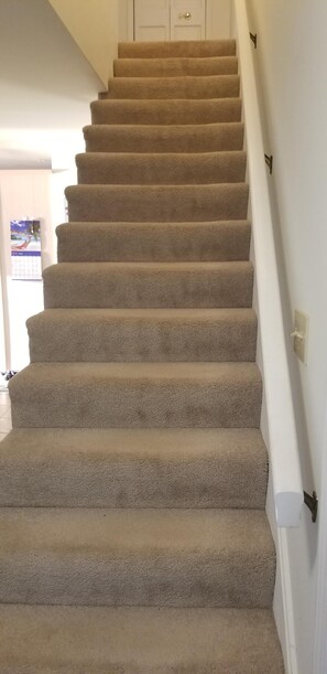 Stairs to upstairs by front door. 