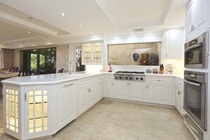 A true chefs kitchen with a gas stove,warming drawer,sub zero & Miele appliances