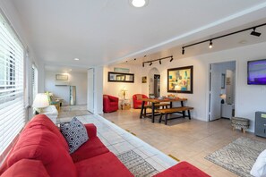 Living Room - A spacious area connecting dining, living, kitchen, and entertainment all in one space!