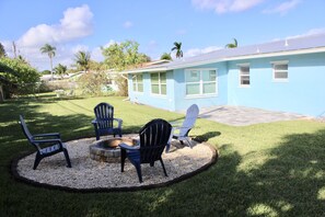 fenced in backyard with patio and fire-pit