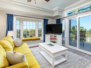 Open Living area with sleeper sofa, TV and views of the bay