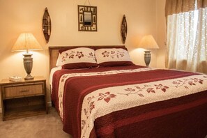 Queen-sized bed in bedroom; with Flat screen TV.