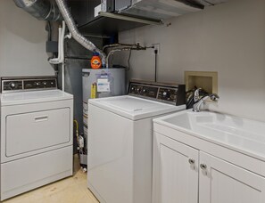 Immediately to the left upon entering is the laundry room, complete with sheets of laundry soap for guest use