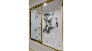 Downstairs full bath with a painted view beside the laundry room